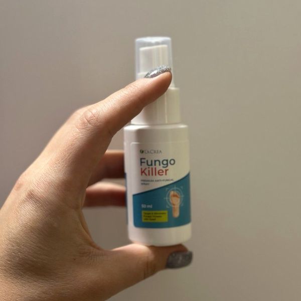 Mano que sostiene el espray de Fungo Killer visto de lado