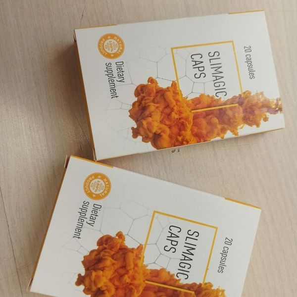 Dos cajas de Slimagic Caps de 20 cápsulas sobre una mesa de madera