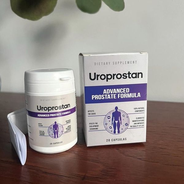 Bote blanco y caja gris de Uroprostan con el prospecto, sobre una mesa oscura